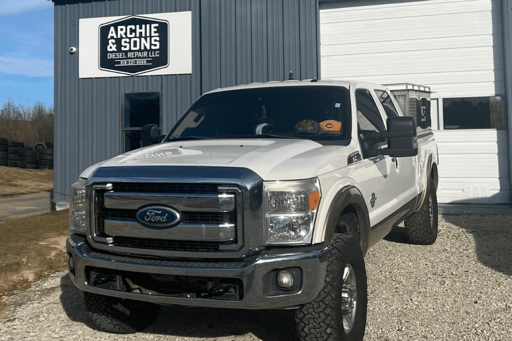 Ford Super Duty pickup truck parked outside Archie & Sons Diesel Repair LLC, showcasing the shop’s commitment to professional diesel maintenance services in a clean, well-maintained facility.