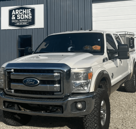 Ford Super Duty pickup truck parked outside Archie & Sons Diesel Repair LLC, showcasing the shop’s commitment to professional diesel maintenance services in a clean, well-maintained facility.