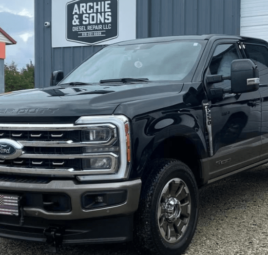 Diesel truck maintenance in Goldsboro, NC by Archie & Sons Diesel Repair. Image of black Ford Super Duty outside repair shop.